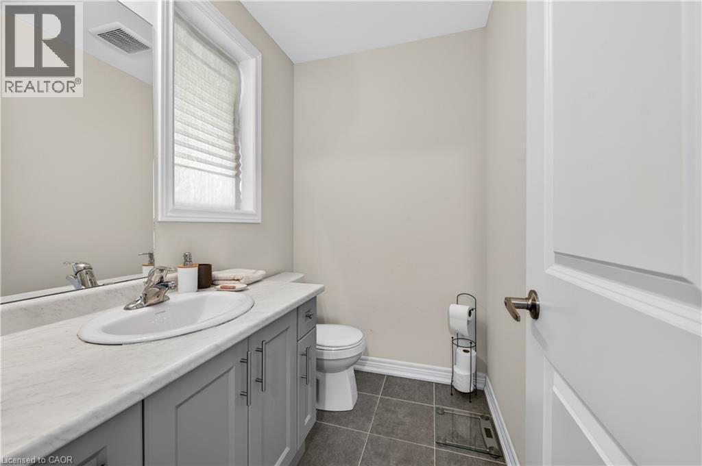 Vanity with light-toned countertop, undermount sink, and chrome faucet - 19 Picardy Drive Unit# 13, Hamilton, ON - Indoor Photo Showing Bathroom