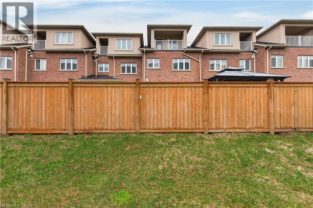 Manicured lawn with a wood plank fence - 19 Picardy Drive Unit# 13, Hamilton, ON - Outdoor