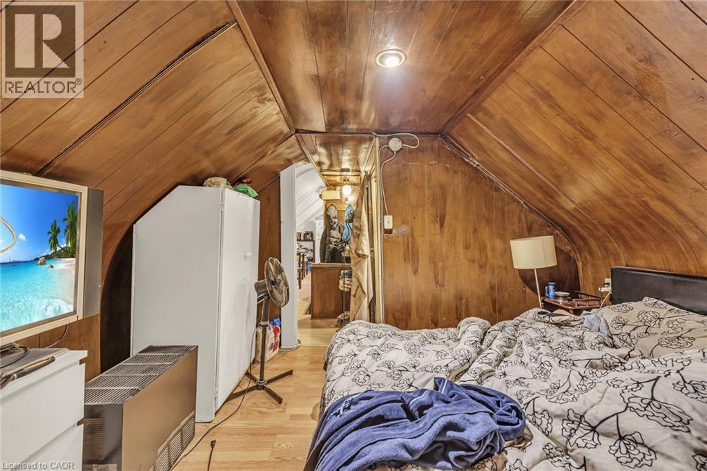 Wood-paneled walls and ceiling featuring a recessed light fixture - 1367 Cannon Street E, Hamilton, ON - Indoor Photo Showing Bedroom