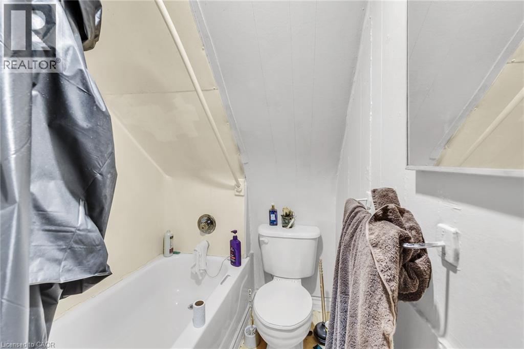 White porcelain toilet - 1367 Cannon Street E, Hamilton, ON - Indoor Photo Showing Bathroom