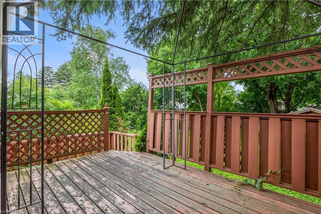 Spacious composite deck featuring wood-finish flooring, decorative lattice railings with geometric patterns, and integrated arbor archway - 695 Glen Forrest Boulevard Unit# Upper, Waterloo, ON - Outdoor