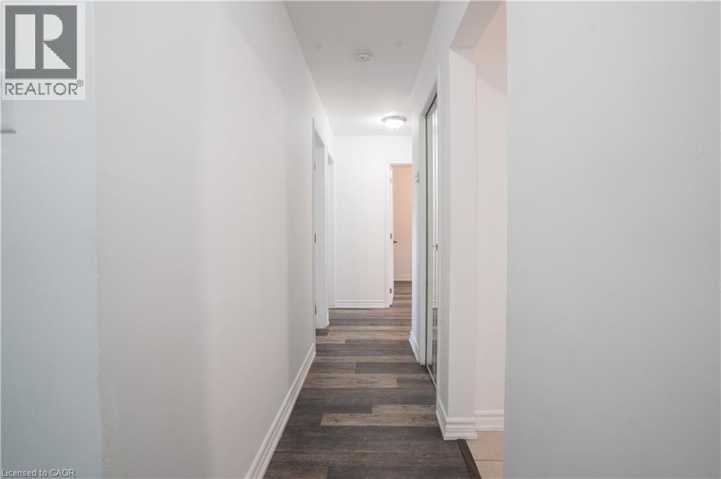 Bright hallway with clean white walls, dark wood-finish flooring, and recessed ceiling lighting - 695 Glen Forrest Boulevard Unit# Upper, Waterloo, ON - Indoor Photo Showing Other Room