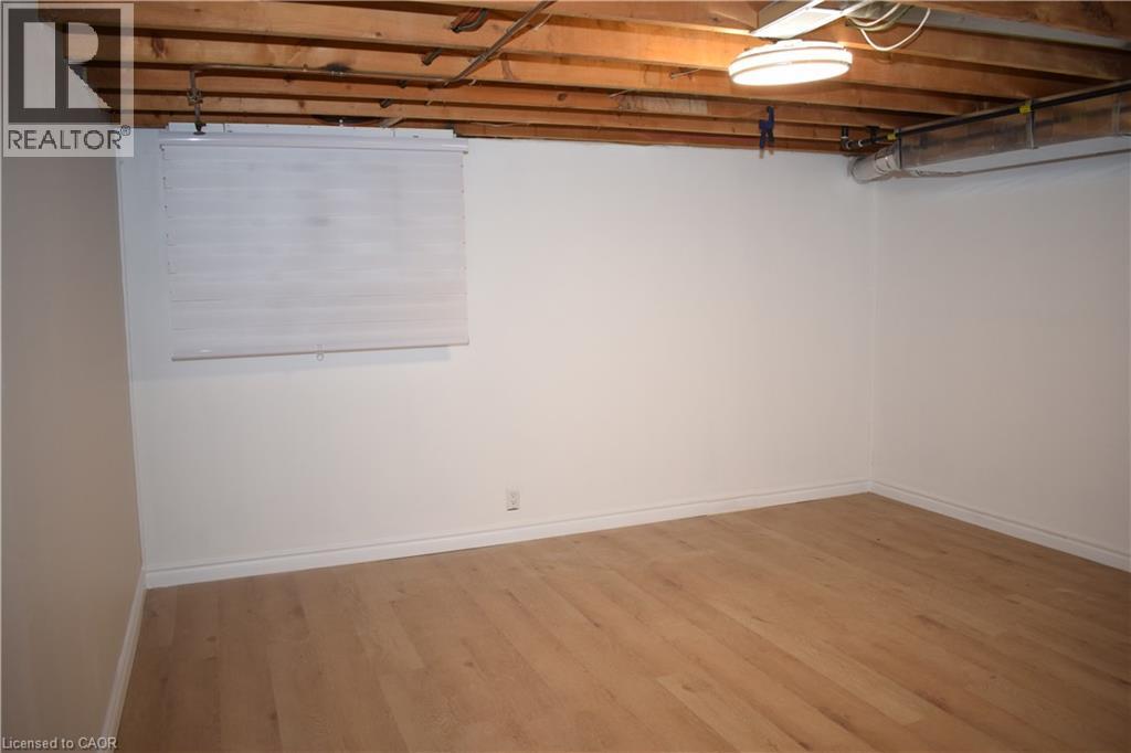Wood-finish flooring, white walls, exposed wood ceiling joists, and a window blind - 655 Albert Street Unit# A, Waterloo, ON - Indoor