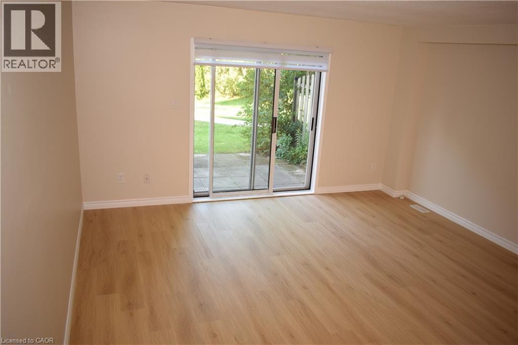 Wood-finish flooring with white trim - 655 Albert Street Unit# A, Waterloo, ON - Indoor Photo Showing Other Room