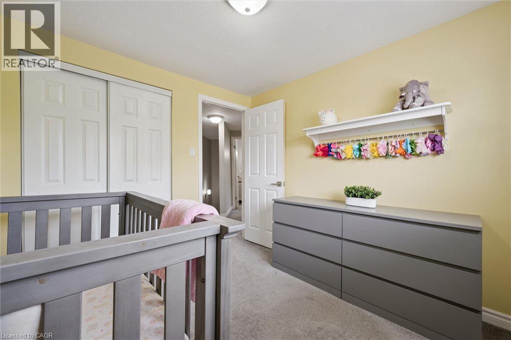 Sliding closet doors, wall-mounted shelving, six-drawer dresser, and flush-mount ceiling light - 60 Elmsdale Drive Unit# 25, Kitchener, ON - Indoor