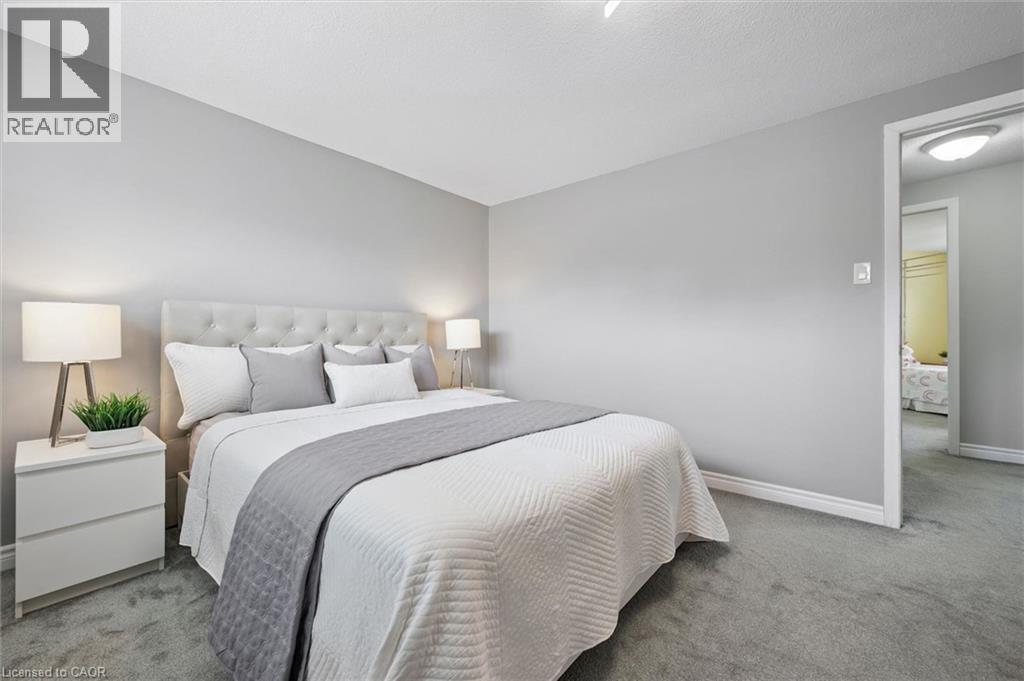 Wall-to-wall carpeting, light gray wall paint, and white trim - 60 Elmsdale Drive Unit# 25, Kitchener, ON - Indoor Photo Showing Bedroom