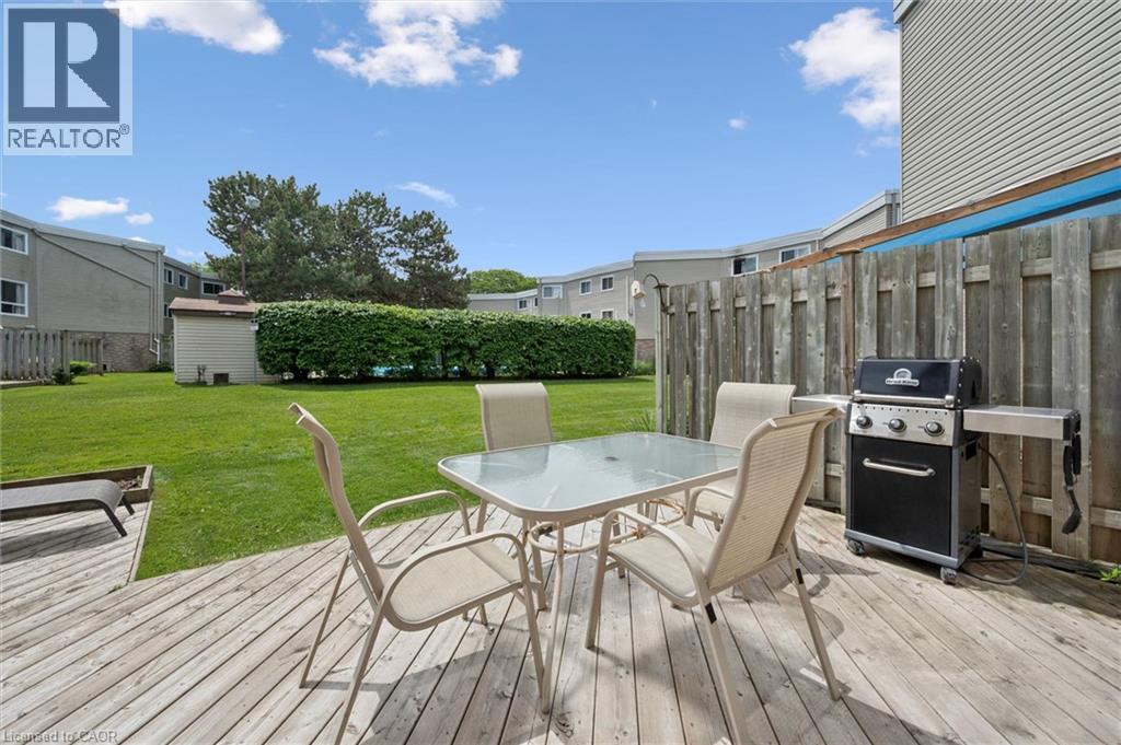Expansive wood deck with a privacy fence - 60 Elmsdale Drive Unit# 25, Kitchener, ON - Outdoor With Deck Patio Veranda With Exterior