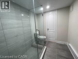 Walk-in shower with full glass enclosure, large format wall tile, and recessed ceiling lighting - 15 Pinecrest Drive Unit# Lower, Kitchener, ON - Indoor Photo Showing Bathroom