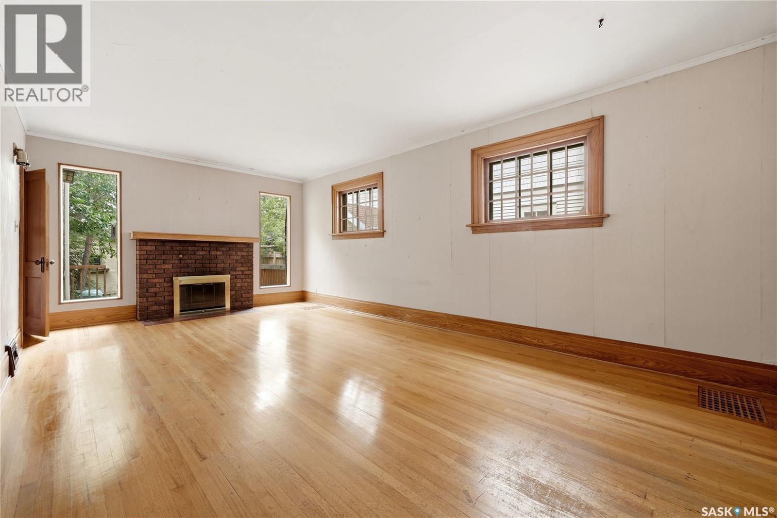 21 Angus Crescent, Regina, SK - Indoor Photo Showing Other Room With Fireplace