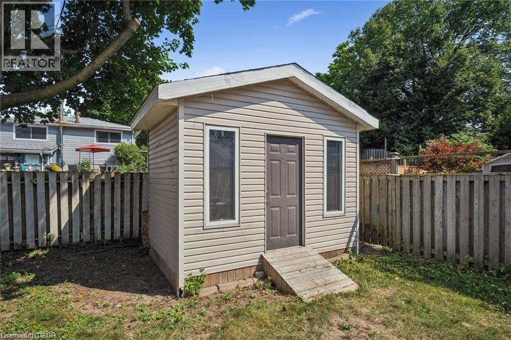 Charming backyard retreat featuring horizontal vinyl siding, peaked roof with overhang, and three full-height doors providing ample natural light - 659 Glen Forrest Boulevard, Waterloo, ON - Outdoor