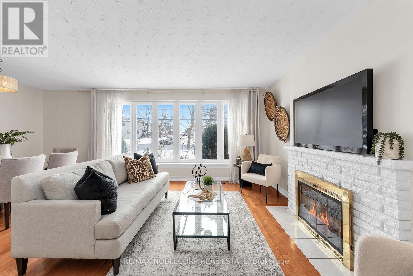 4230 Bloor Street W, Toronto, ON - Indoor Photo Showing Living Room With Fireplace