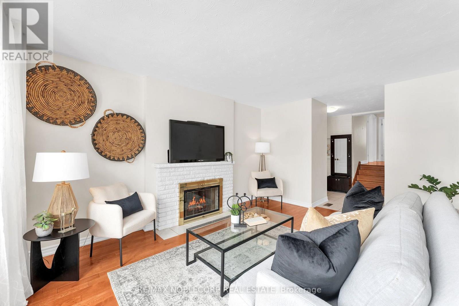 4230 Bloor Street W, Toronto, ON - Indoor Photo Showing Living Room With Fireplace