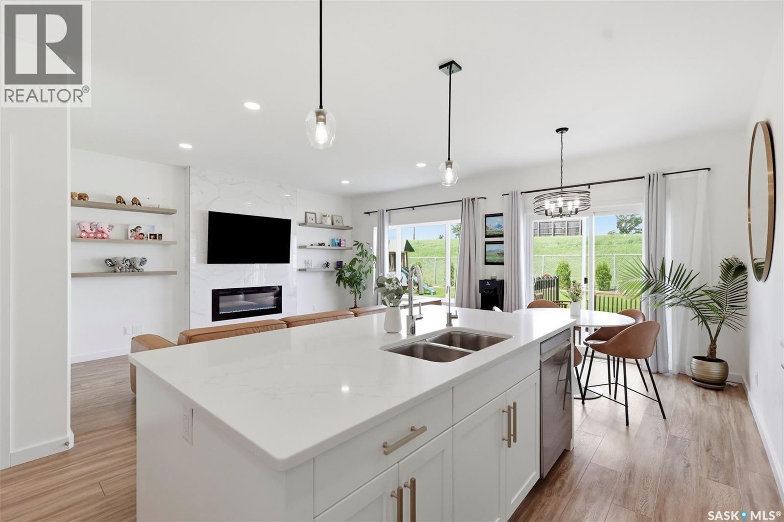 421 Germain Manor, Saskatoon, SK - Indoor Photo Showing Kitchen With Fireplace With Double Sink