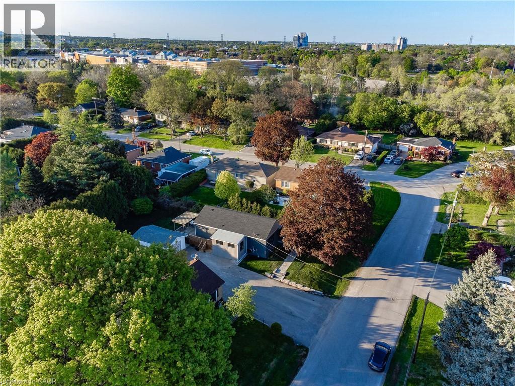 Aerial view of an established residential neighborhood featuring mature landscaping with specimen trees, manicured lawns, and tree-lined streets - 1041 Shepherd'S Drive, Burlington, ON - Outdoor With View