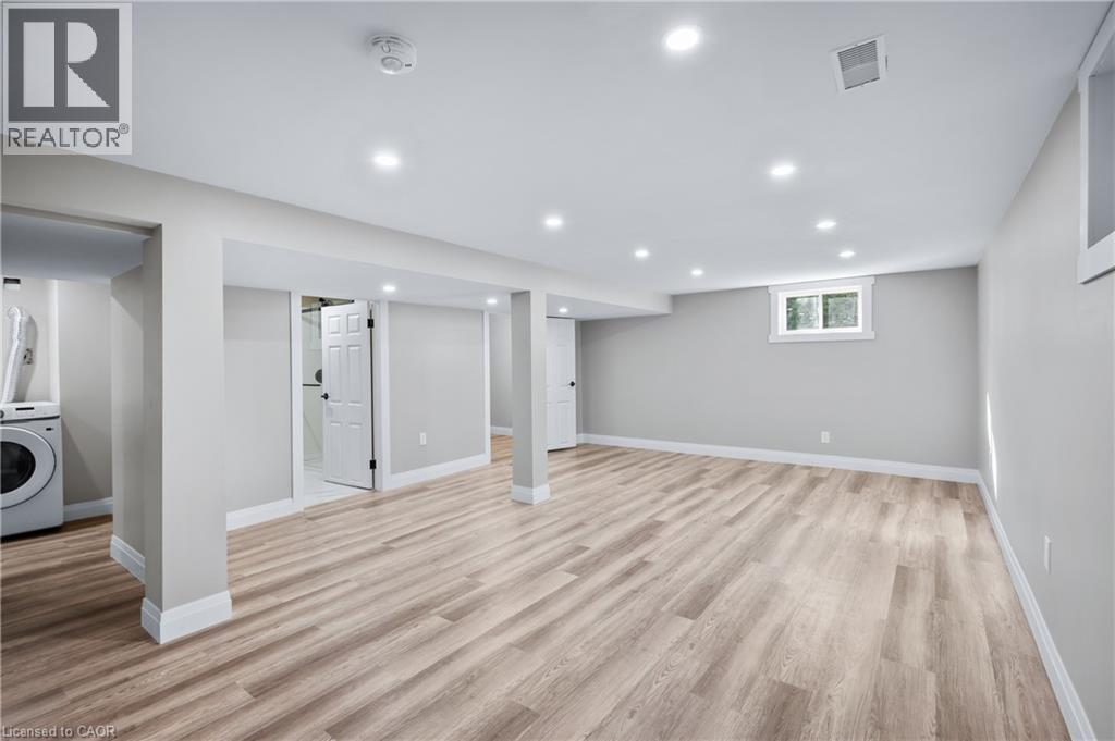 Finished lower level featuring recessed lighting, light wood-finish flooring, and painted walls - 1041 Shepherd'S Drive, Burlington, ON - Indoor