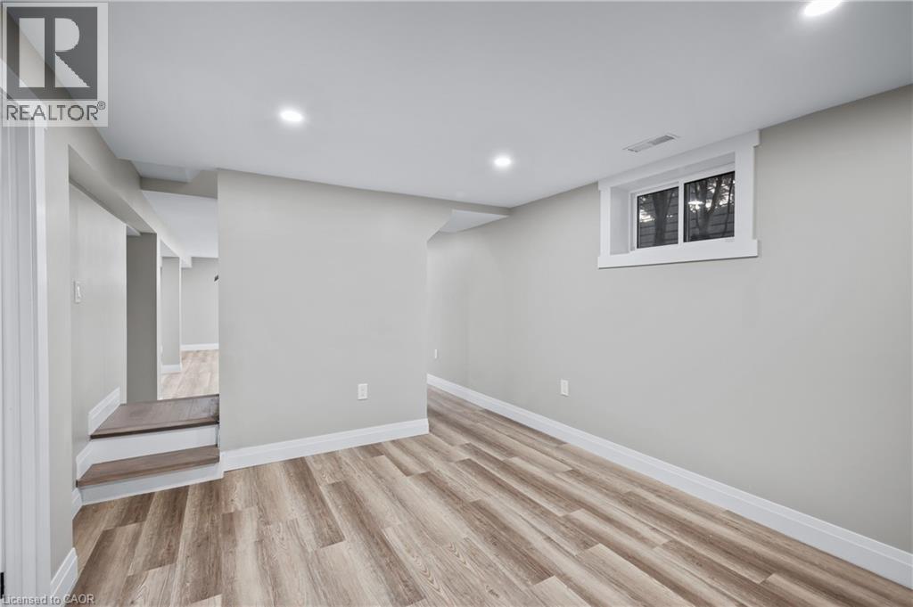 Recessed lighting, wood-finish flooring, white trim, and a window with white casing - 1041 Shepherd'S Drive, Burlington, ON - Indoor