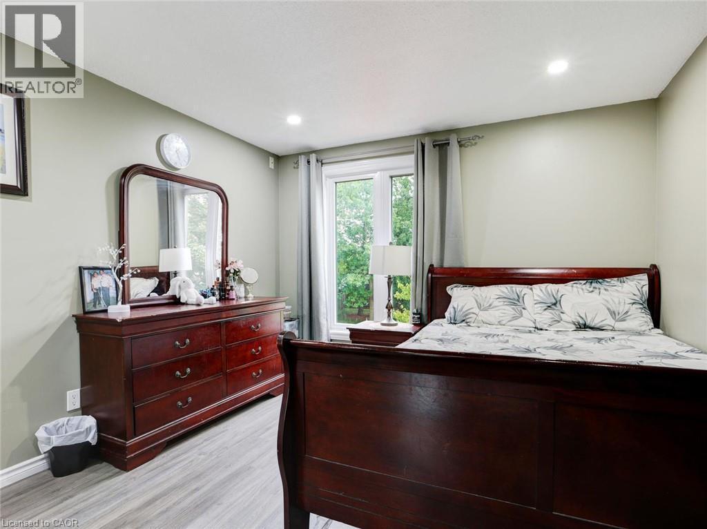 Recessed lighting, wood-finish flooring, and a large sliding glass door - 128 Macatee Place, Cambridge, ON - Indoor Photo Showing Bedroom
