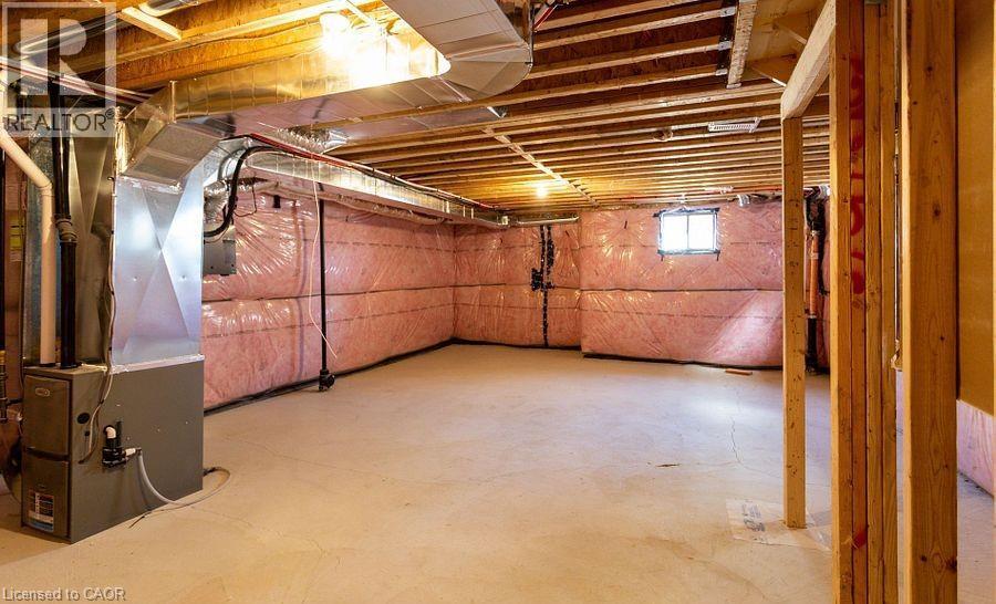 Unfinished basement with exposed ceiling joists, concrete flooring, and insulated perimeter walls - 16 Monteith Drive, Brantford, ON - Indoor Photo Showing Basement