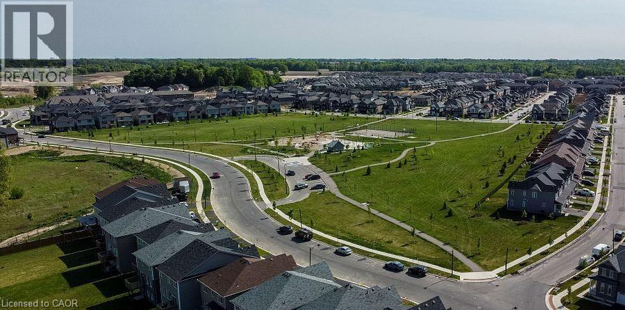 Well-defined residential neighborhood featuring a central green space, paved pathways, and multiple street networks - 16 Monteith Drive, Brantford, ON - Outdoor With View