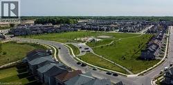 Well-defined residential neighborhood featuring a central green space, paved pathways, and multiple street networks - 