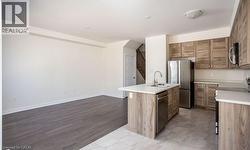 Spacious open-concept layout with wood-finish flooring - 