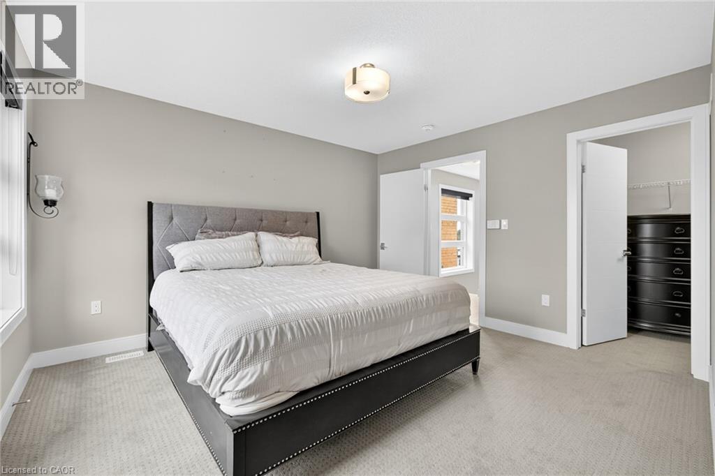 Neutral wall paint, light-toned carpet flooring, recessed lighting, ceiling-mounted light fixture, white trim - 60 Arkell Road Unit# 57, Guelph, ON - Indoor Photo Showing Bedroom