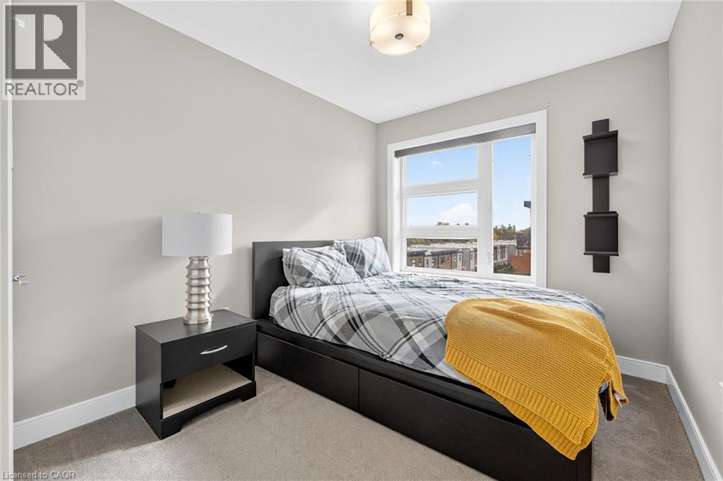 Recessed window with white trim, light gray wall paint, and gray carpet - 60 Arkell Road Unit# 57, Guelph, ON - Indoor Photo Showing Bedroom