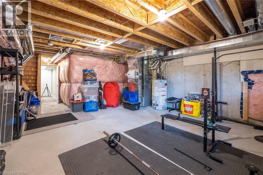 Unfinished basement with concrete flooring and exposed ceiling joists - 60 Arkell Road Unit# 57, Guelph, ON - Indoor Photo Showing Basement