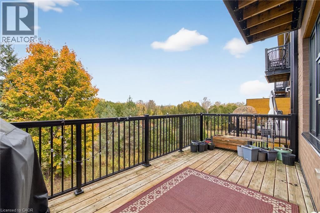 Wood-finish decking with black metal railings - 60 Arkell Road Unit# 57, Guelph, ON - Outdoor With Balcony With Exterior