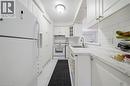 Kitchen featuring white cabinetry, white subway tile backsplash, light-colored countertops, and stainless steel sink - 230 Sunset Boulevard, Cambridge, ON  - Indoor Photo Showing Kitchen With Double Sink 