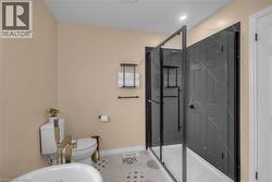 Modern bathroom featuring a freestanding soaking tub with gold-tone hardware - 