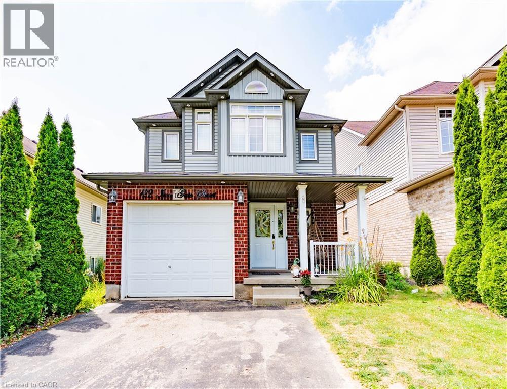 Two-story residence featuring a brick and siding exterior, an attached single-car garage, and a covered front porch - 122 Iron Gate Street, Kitchener, ON - Outdoor With Facade