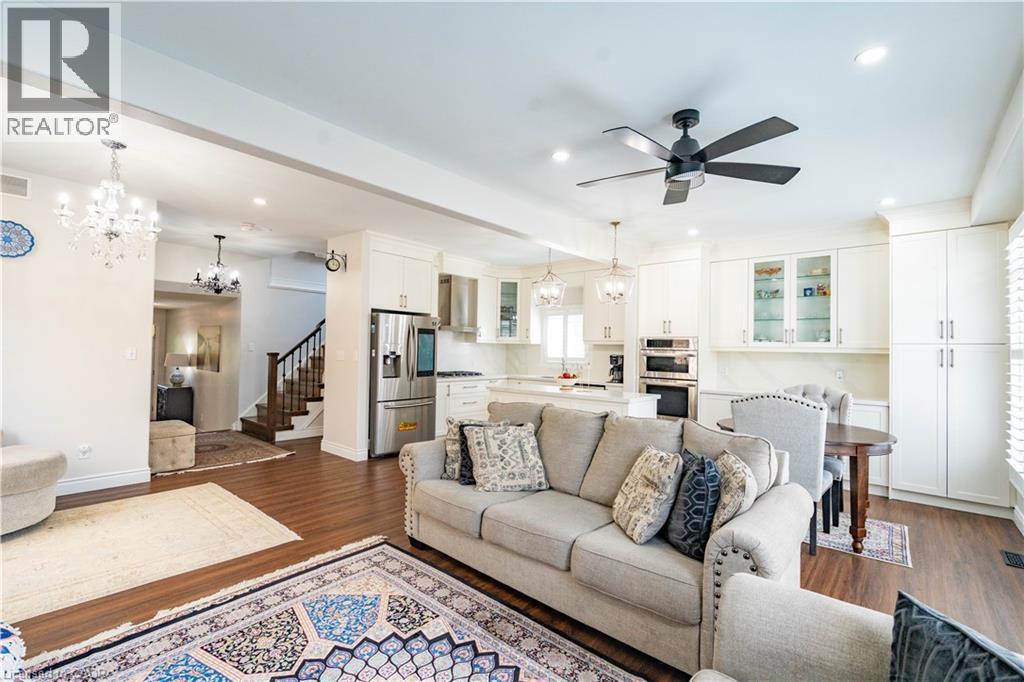 Open-concept living space with dark wood-finish flooring, recessed lighting, and a modern ceiling fan - 122 Iron Gate Street, Kitchener, ON - Indoor Photo Showing Living Room