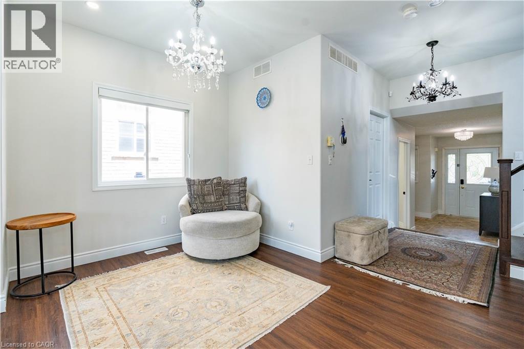 Recessed lighting, wood-finish flooring, white window trim, and two chandeliers - 122 Iron Gate Street, Kitchener, ON - Indoor