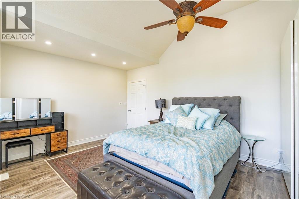 Vaulted ceiling, wood-finish flooring, recessed lighting, ceiling fan, and paneled door - 122 Iron Gate Street, Kitchener, ON - Indoor Photo Showing Bedroom