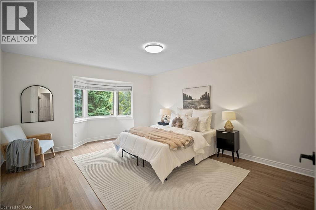 Light wood-finish flooring, white walls, and a bay window - 320 Hamilton Drive Unit# 10, Ancaster, ON - Indoor Photo Showing Bedroom