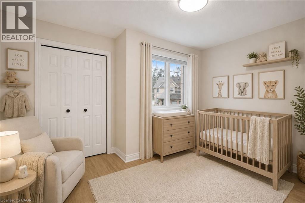 Serene nursery featuring hardwood flooring, large casement windows with natural light, and soft neutral wall tones - 320 Hamilton Drive Unit# 10, Ancaster, ON - Indoor Photo Showing Bedroom