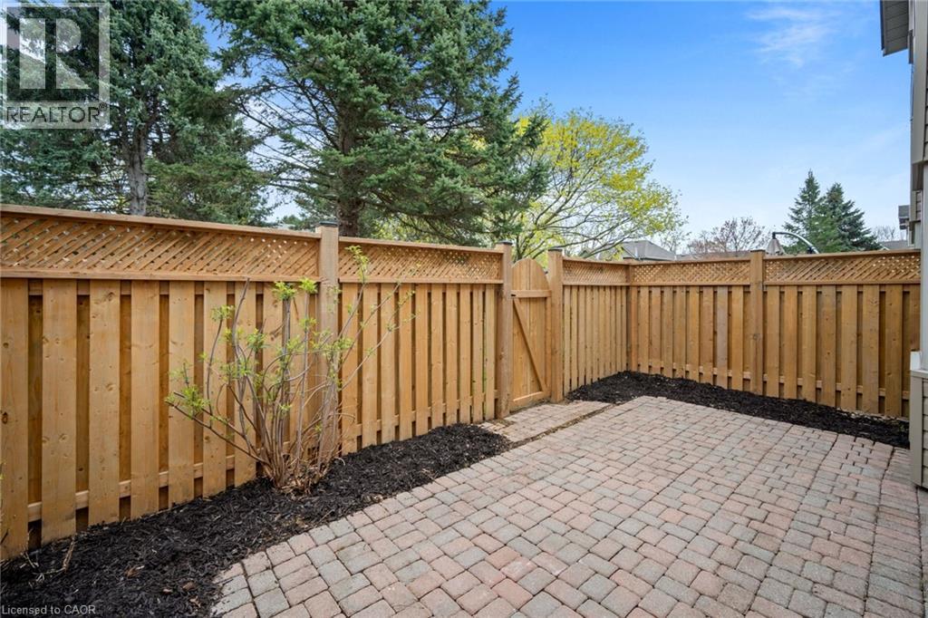 Paved patio area with brick-style pavers and surrounding mulch beds - 320 Hamilton Drive Unit# 10, Ancaster, ON - Outdoor