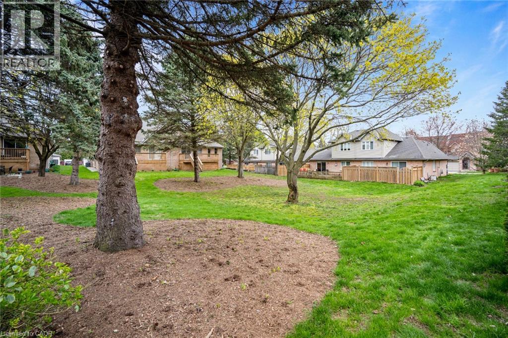 Expansive green space featuring mature trees and a manicured lawn - 320 Hamilton Drive Unit# 10, Ancaster, ON - Outdoor
