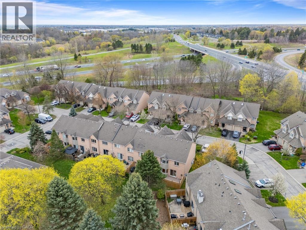 Townhome community with private backyard spaces, individual garages, and mature landscaping - 320 Hamilton Drive Unit# 10, Ancaster, ON - Outdoor With View