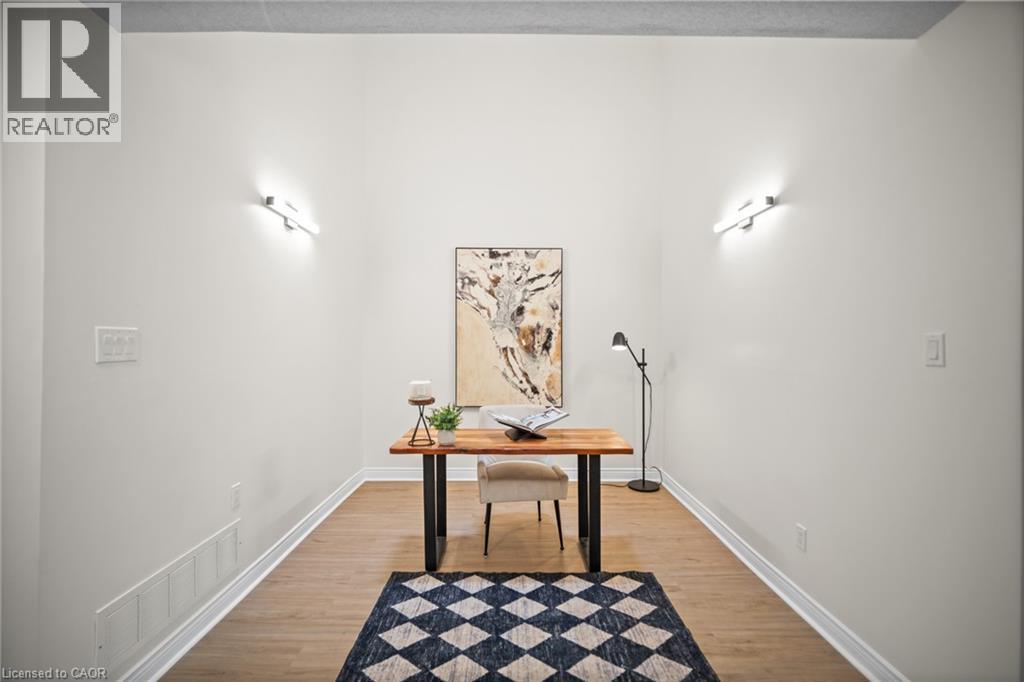 Wood-finish flooring with white baseboards, complemented by bright white walls and recessed ceiling - 320 Hamilton Drive Unit# 10, Ancaster, ON - Indoor Photo Showing Other Room