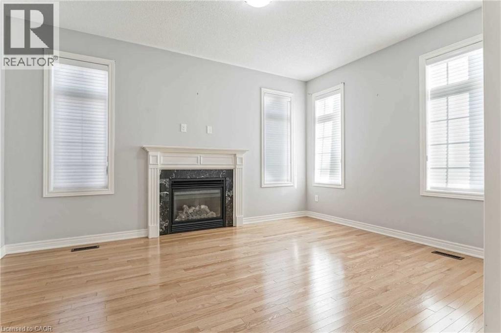 Unfurnished living room featuring light wood-style floors and a premium fireplace - 3 Coolwater Drive Unit# Upper, Brampton, ON - Indoor Photo Showing Living Room With Fireplace