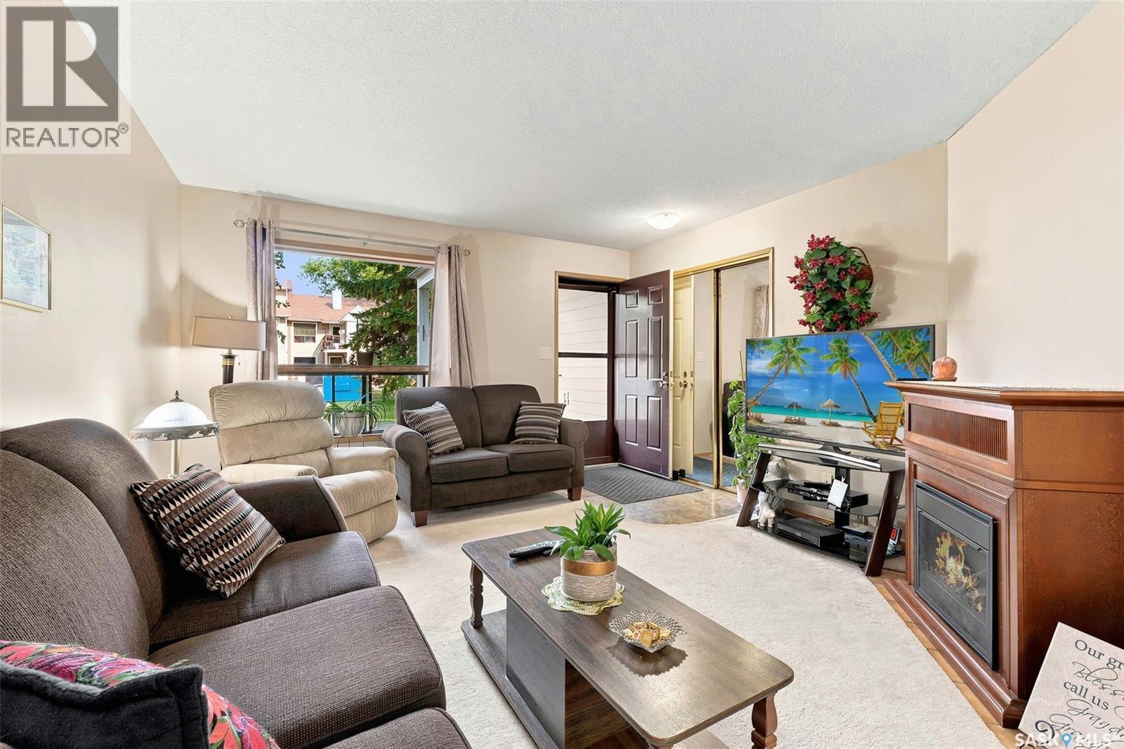 386 Cedar Meadow Drive, Regina, SK - Indoor Photo Showing Living Room With Fireplace