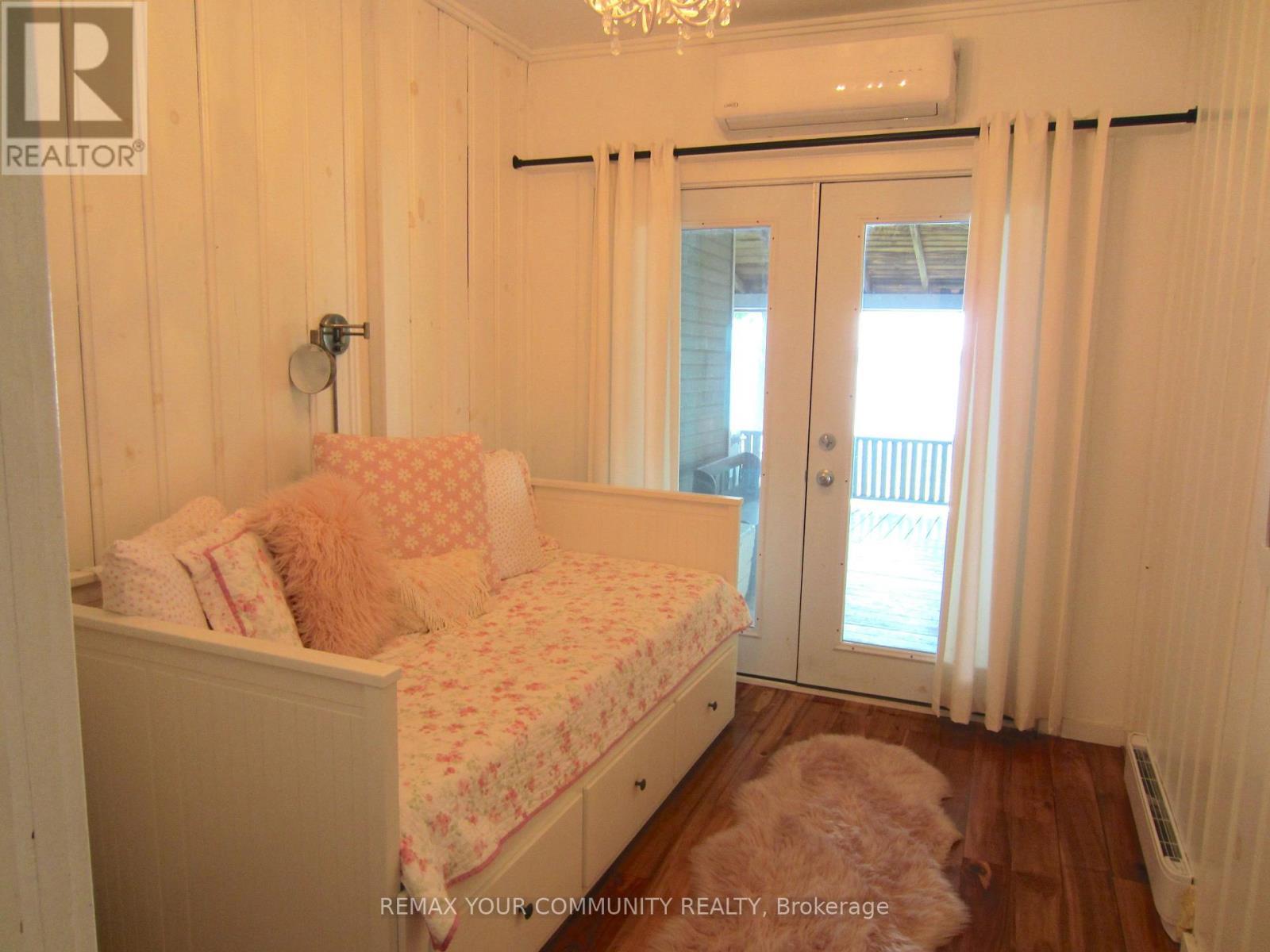 Adorable Bedroom #4 with walkout to Front Porch - 6576 Quarry Point Road, Ramara, ON - Indoor Photo Showing Bedroom