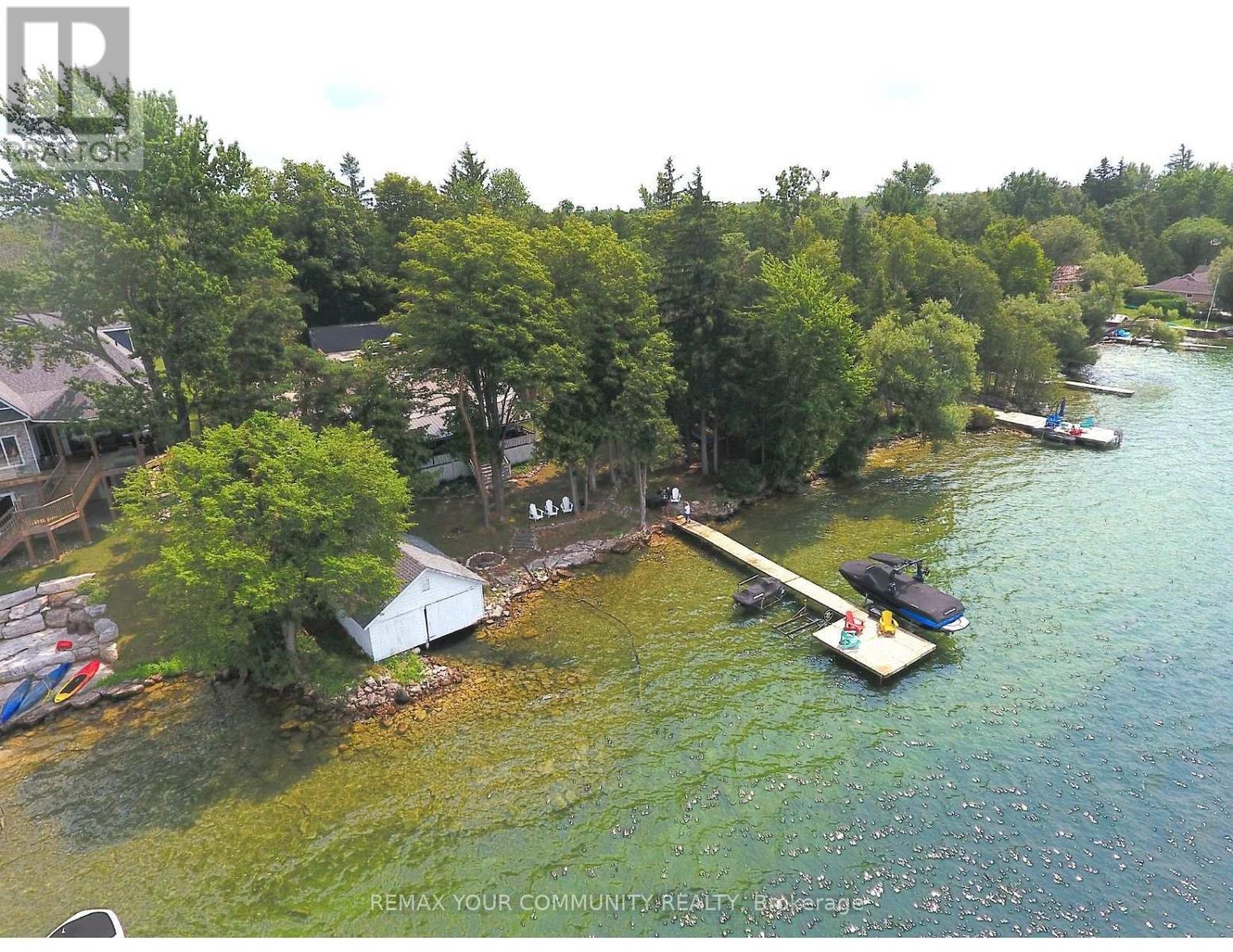 Long Shot of Shoreline and Dock - 6576 Quarry Point Road, Ramara, ON - Outdoor With Body Of Water With View