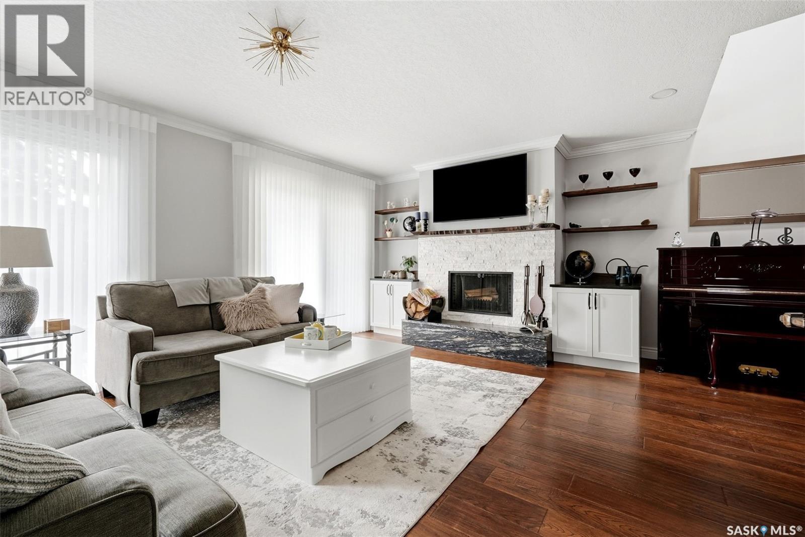 1142 Gryphons Walk, Regina, SK - Indoor Photo Showing Living Room With Fireplace
