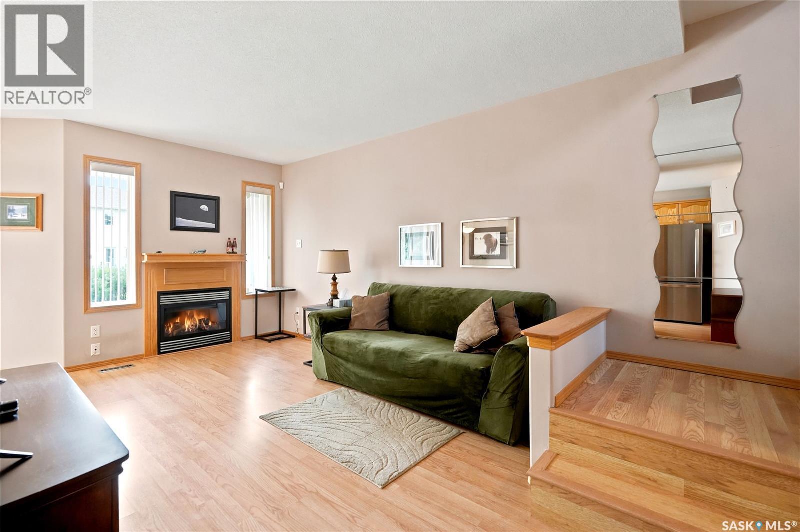 225 Mikkelson Drive, Regina, SK - Indoor Photo Showing Living Room With Fireplace