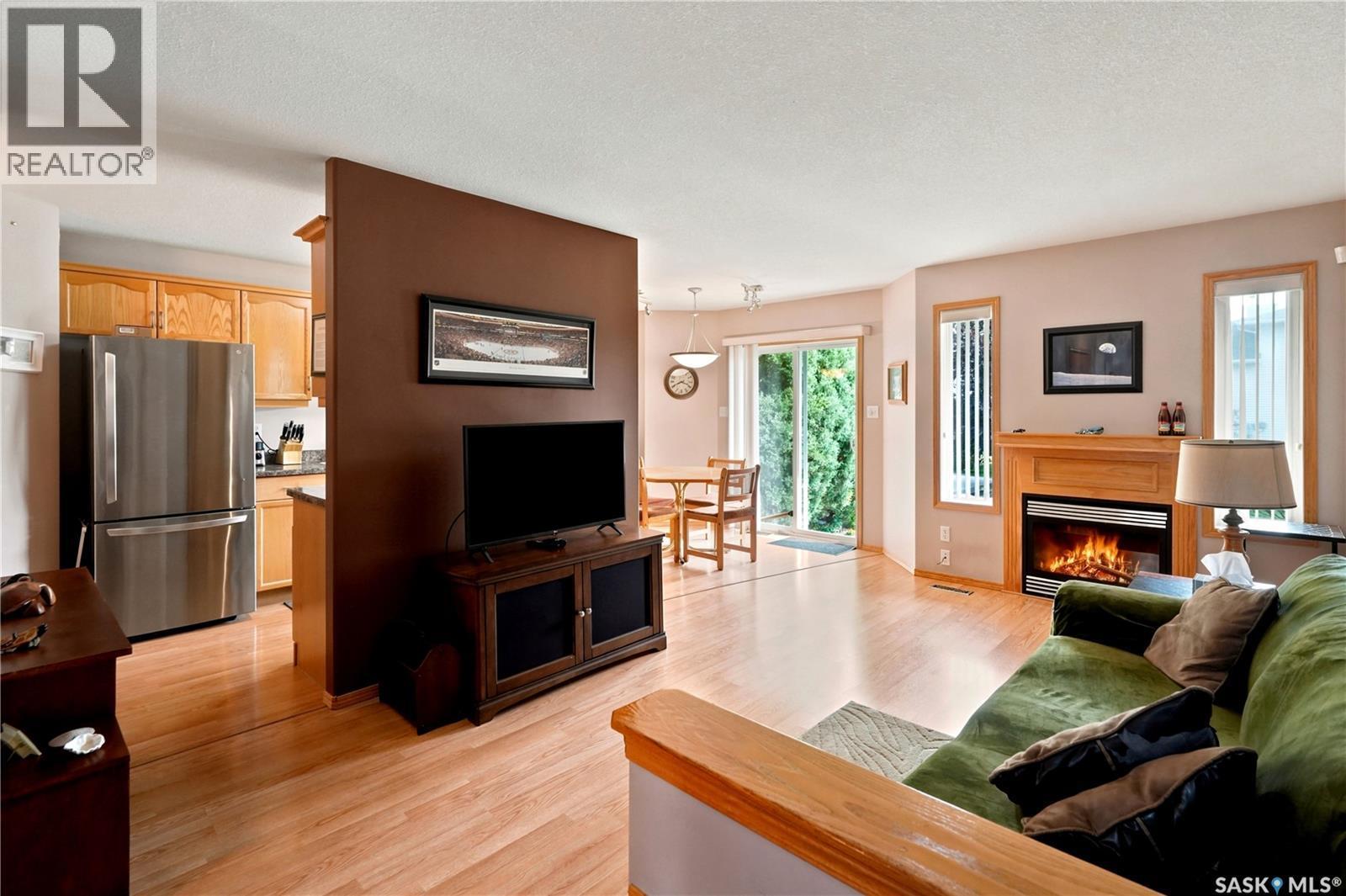 225 Mikkelson Drive, Regina, SK - Indoor Photo Showing Living Room With Fireplace