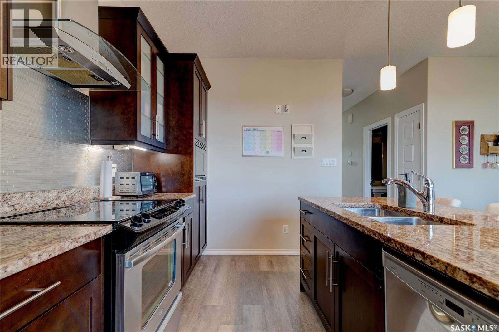 137 3229 Elgaard Drive, Regina, SK - Indoor Photo Showing Kitchen With Stainless Steel Kitchen With Double Sink