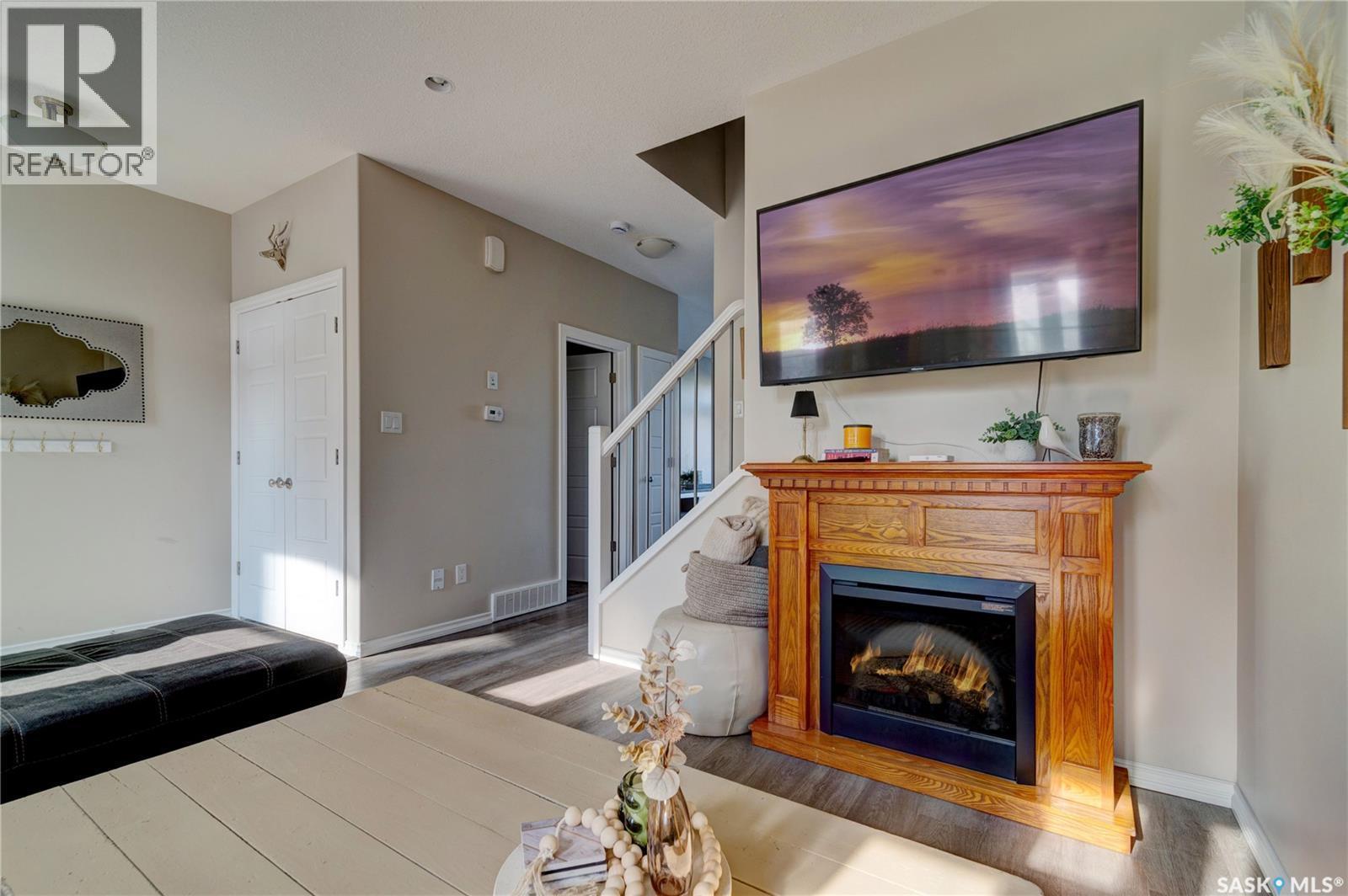 137 3229 Elgaard Drive, Regina, SK - Indoor Photo Showing Living Room With Fireplace